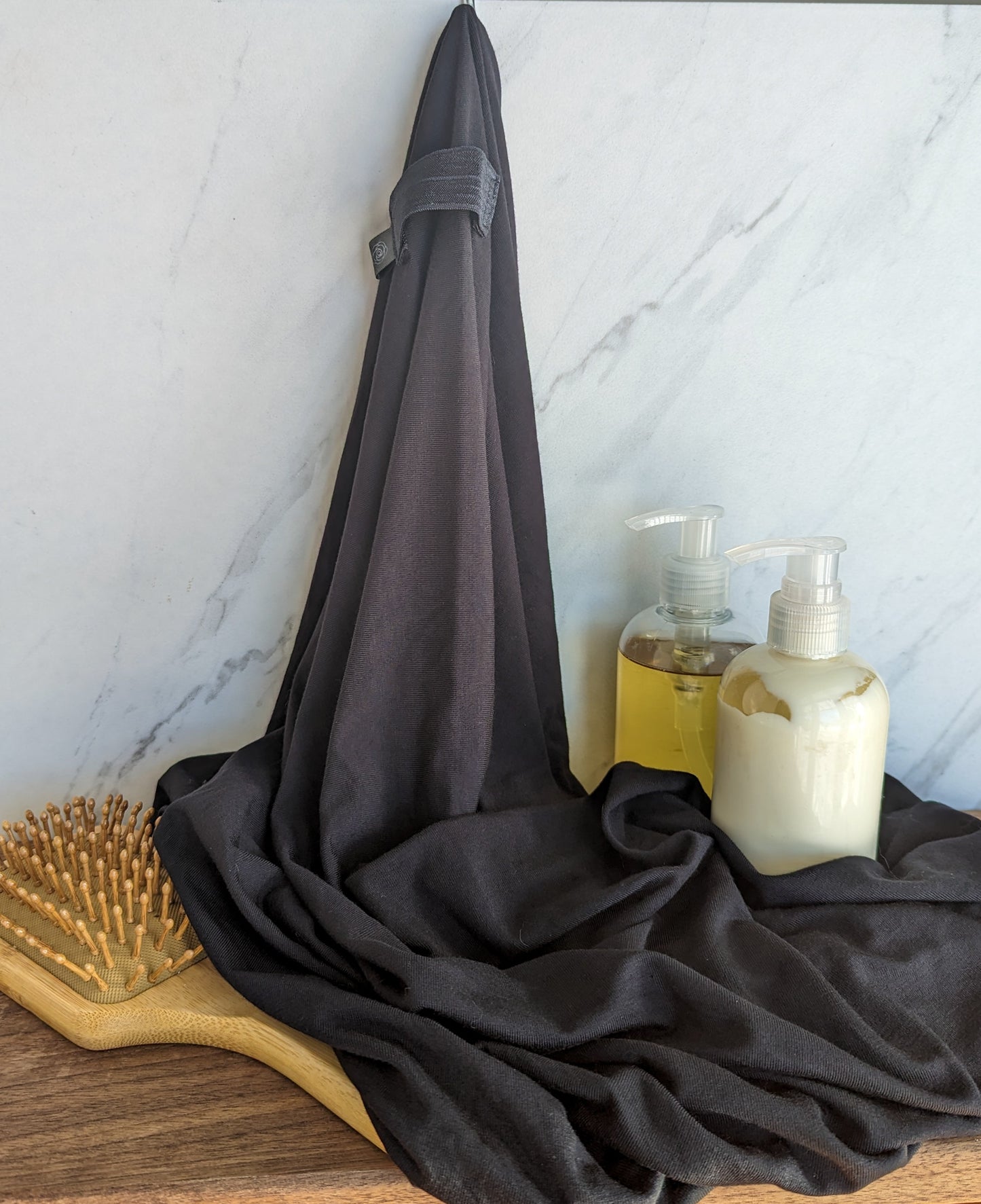 black bamboo hair towel with brush in bathroom