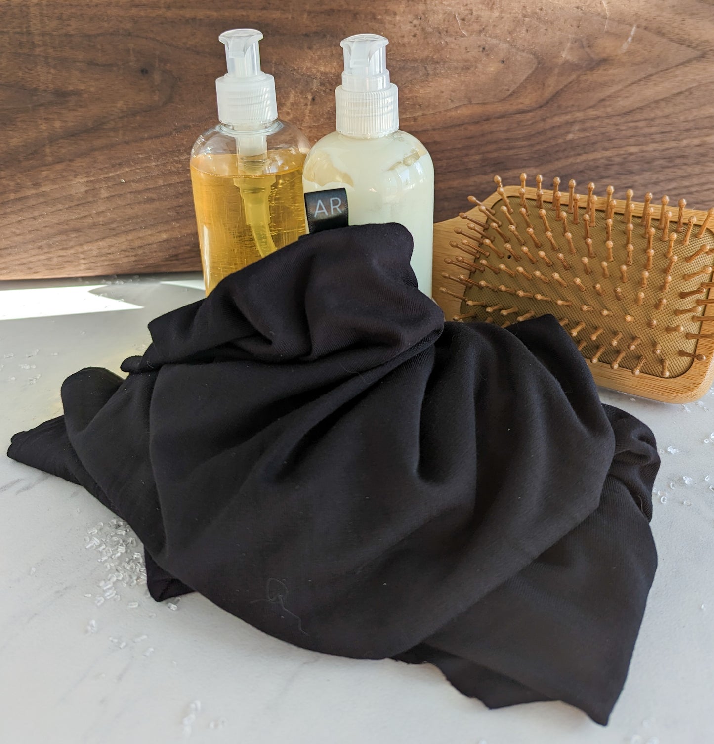 black bamboo hair towel with shampoo and brush